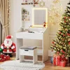 A vanity table with a stool and a Christmas tree decorated with lights and ornaments, along with a Santa Claus figure and gift boxes, suggesting a festive holiday setting. Anteprima dell’immagine prodotto