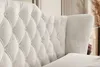 Close-up view of a tufted headboard and wingback of a bed. Produktbild-Vorschau