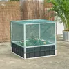 A raised garden bed with a mesh cover, containing rose bushes, is situated on a patio. A potted palm tree and a woven fence are visible in the background. Produktbild-Vorschau