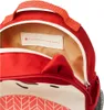 A close-up view of the inside of a red backpack, showing a name tag and the zipper. Anteprima dell’immagine prodotto