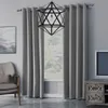 A living room scene with a window covered by gray curtains, a chair, and a TV stand. Voir les images du produit