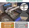 A grey upholstered bed frame with its storage compartment open, revealing organized storage bins. The bed has blue LED lighting along the headboard and base. Inset images show details of the bed's lifting mechanism and straps. Produktbild-Vorschau