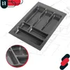 A gray cutlery organizer tray is shown at an angle on top of architectural blueprints. A close-up inset of the tray's compartments is visible in the bottom left corner. A logo is present in the top left corner. Voir les images du produit