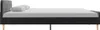 Side view of a dark gray fabric bed frame with two white pillows on a white background. Podgląd zdjęcia produktu