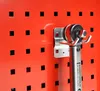 A close-up of a torque wrench hanging on a pegboard. Produktbild-Vorschau