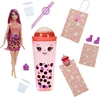 A Barbie doll and boba-themed accessories are arranged on a white background. Podgląd zdjęcia produktu