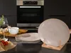 A kitchen counter with plates, wine, and ingredients. Produktbild-Vorschau