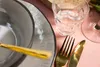 A close-up of a table setting with a plate, bowl, fork, knife, and glass. Náhled obrázku produktu