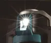 A close-up shot of the top of a Makita DTM52Z Akku-Multitool, with its LED light illuminated. Produktbild-Vorschau