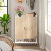 A shoe cabinet with decorative elements in a bedroom setting. Produktbild-Vorschau