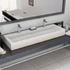 A modern bathroom sink with two faucets reflected in a mirror. Anteprima dell’immagine prodotto