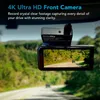 A dashcam mounted on a car windshield, showing a road scene. Produktbild-Vorschau