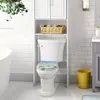 A toilet with a decorative seat cover in a bathroom setting. Produktbild-Vorschau