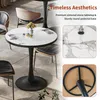 A round marble-top table with a black pedestal base, shown in a dining or cafe setting with chairs. Anteprima dell’immagine prodotto