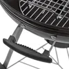 A close-up view of a black kettle grill's handle and part of the grill grate. Produktbild-Vorschau