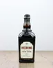 A bottle of Heering Cherry Liqueur is placed on a wooden surface against a white background. Produktbild-Vorschau