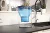 A water filter pitcher sits on a kitchen counter next to a sink. Náhľad obrázku produktu