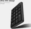 A close-up, angled shot of a black wireless numeric keypad against a light gray and white background, with marketing text on the left. Podgląd zdjęcia produktu