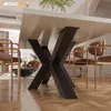 A close-up view of a table base with chairs around it in a dining room setting. Produktbild-Vorschau