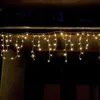 Icicle lights hanging from a wooden overhang at night. Produktbild-Vorschau
