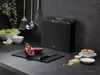 A kitchen counter with a set of cutting boards, a pomegranate, and other ingredients. Anteprima dell’immagine prodotto