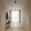 A hallway with a coat rack, a bench, and a large window with sheer curtains. Náhľad obrázku produktu