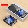 Two black flip phone cases are displayed on a light wooden surface, with one case placed on a white box. Náhled obrázku produktu
