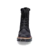 A black lace-up boot with faux fur trim is shown from the front against a white background. Voir les images du produit