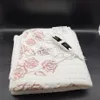 A folded electric blanket with a rose pattern and a controller. Produktbild-Vorschau