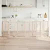 A wooden pet gate is set up in a kitchen, blocking access to the cabinets and appliances. Náhled obrázku produktu