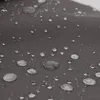 A close-up view of water droplets on a dark gray fabric. Produktbild-Vorschau