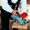 A person is using a circular saw to cut a piece of wood. Produktbild-Vorschau