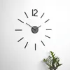 A modern wall clock with a minimalist design, featuring black hour markers and hands on a white wall. Produktbild-Vorschau