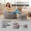 A woman sitting on a large beanbag chair next to a smaller ottoman, with a living room setting in the background. Below, a smaller beanbag and ottoman are shown with a plus sign, indicating a combination or set. Voir les images du produit
