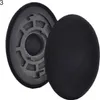 A pair of black ear pads for headphones, with one pad detached and showing the inner foam and plastic frame. Produktbild-Vorschau