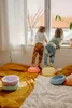 Two children are standing on colorful stepping stones, looking out a window. Anteprima dell’immagine prodotto