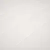A close-up, angled view of a white quilted surface, likely a mattress or a padded table. Anteprima dell’immagine prodotto