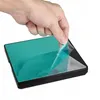 A hand is peeling a protective film off a silver and black electronic device. Produktbild-Vorschau