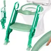 A green and white child's toilet training seat with a step stool attached, placed in front of a toilet. Produktbild-Vorschau