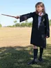 A young girl dressed as Hermione Granger from Harry Potter, holding a wand in an outdoor setting. Produktbild-Vorschau
