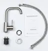 A disassembled kitchen faucet and its accessories are laid out on a white background, along with an instruction manual. Náhled obrázku produktu