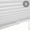 A close-up view of white pleated blinds with a control mechanism visible. Produktbild-Vorschau