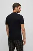 A man wearing a black t-shirt and plaid pants, shown from the back. Produktbild-Vorschau