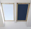 Two skylight windows, one with a light blue sky visible and the other covered by a dark blue blackout blind. Produktbild-Vorschau