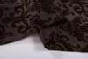 A close-up of a brown fabric with a damask pattern, folded. Produktbild-Vorschau