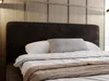 A close-up view of a bed with a dark headboard and white bedding. Produktbild-Vorschau