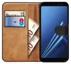 A book-style phone case with a Samsung Galaxy A8 2018 phone inside, showing cards and cash slots. Produktbild-Vorschau