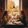 Two women sitting at a table in front of a window with autumn foliage outside, enjoying coffee and conversation. Podgląd zdjęcia produktu