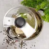 A top-down view of a pot with a glass lid, containing noodles and bay leaves, with peppercorns scattered around. Náhled obrázku produktu