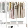 A white metal garment rack with various dresses and clothes hanging on it, and two storage bins on the bottom shelf. Náhled obrázku produktu